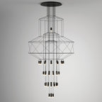 Studio view of the stacked-frame Clérachic chandelier, its octagonal wire shapes above rows of LED drops on a soft grey wall.
