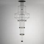 A slim, tall Clérachic wire chandelier with narrow stacked frames and long vertical rows of LED drops, on a grey backdrop.