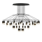 Very wide Clérachic wire chandelier with a flat round canopy, thin wires and dozens of LED terminals hung at many heights.