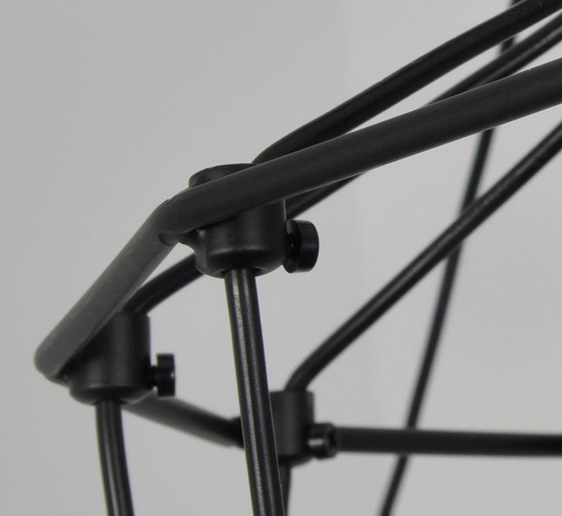 Close view of the black metal rods and small clamp fittings joining the wire frame of this Clérachic chandelier.