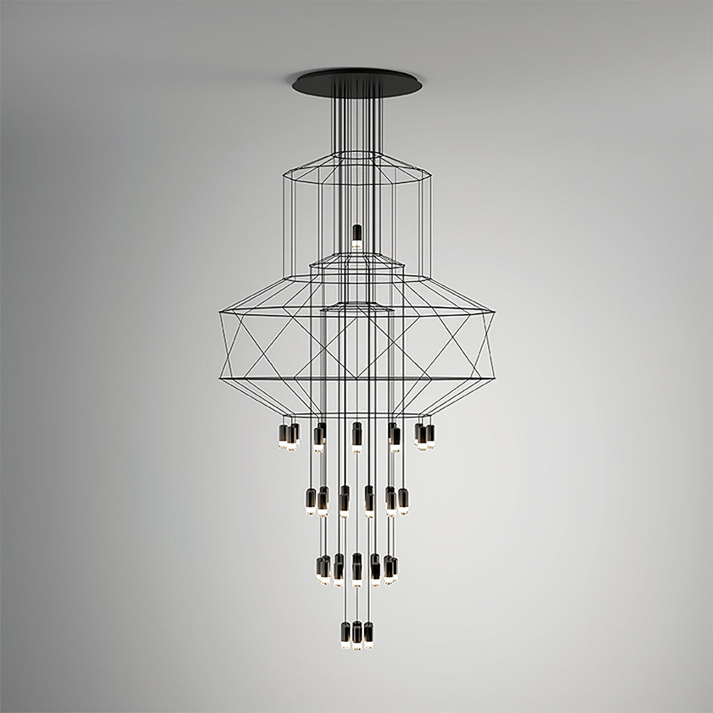 Front view of the Clérachic wire chandelier against a soft grey gradient wall, with LED drops in four tiers.