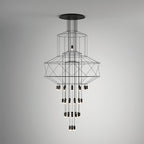 Front view of the Clérachic wire chandelier against a soft grey gradient wall, with LED drops in four tiers.