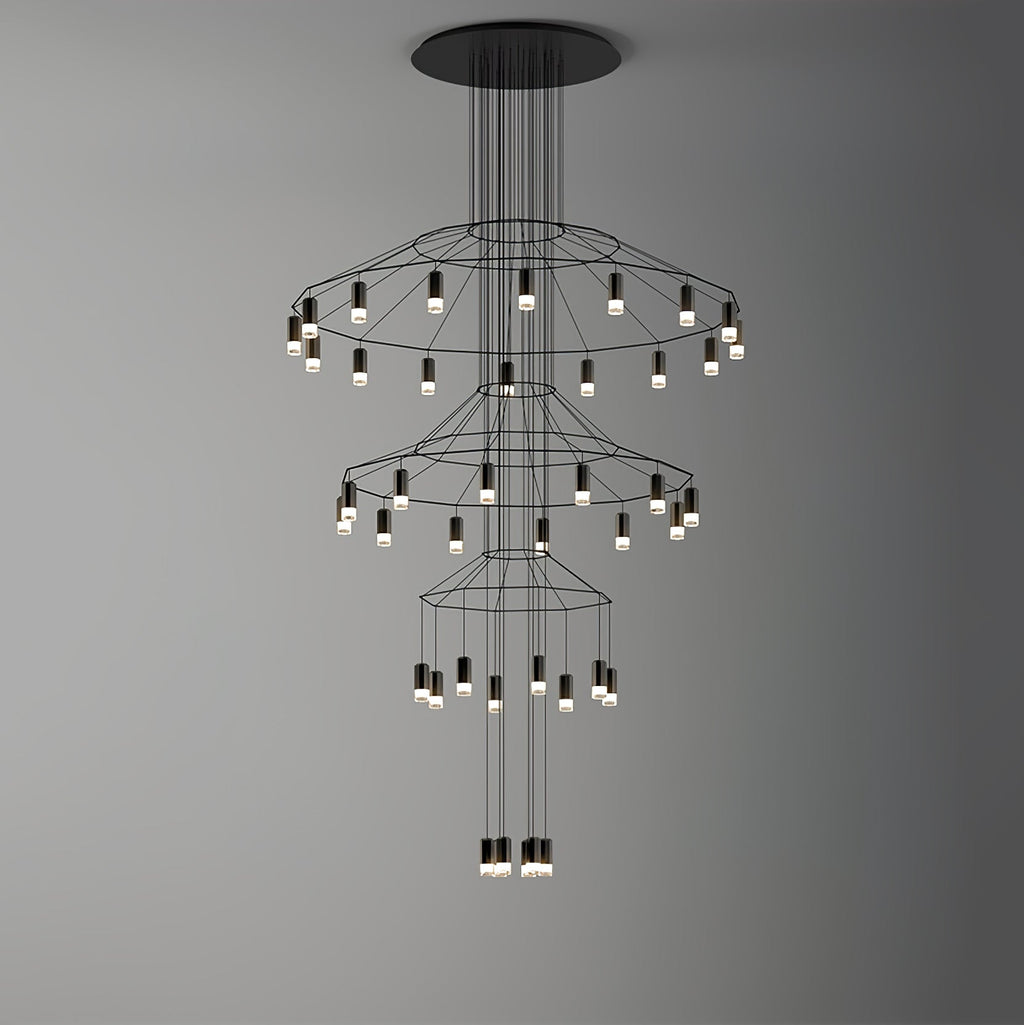 Clérachic wire chandelier with three wide tiers of LED drops hung on a grey backdrop that darkens to the right.
