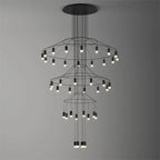 Clérachic three-tier wire chandelier with rings of small LED drops, stepping down to a lit cluster, on a grey gradient.