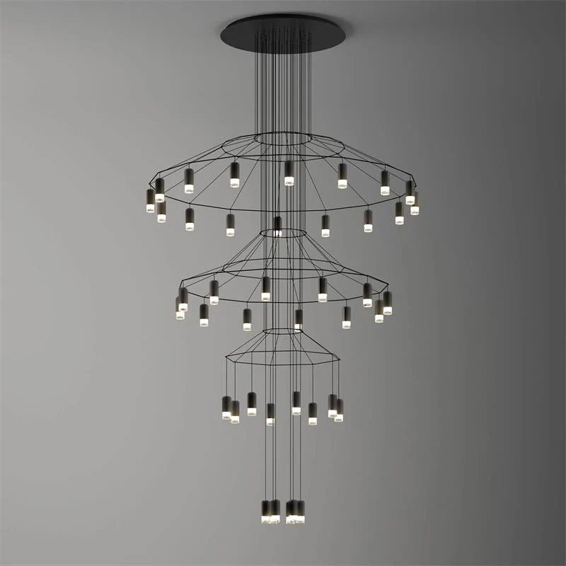 Clérachic three-tier wire chandelier with rings of small LED drops, stepping down to a lit cluster, on a grey gradient.