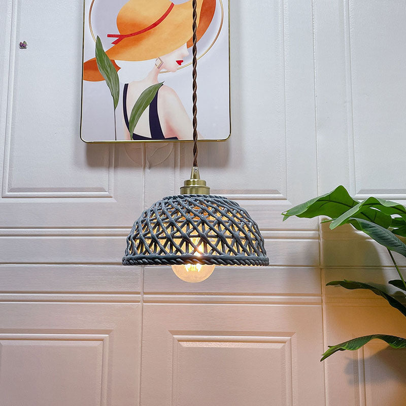 Clérachic pendant light lit, the glow through the shade in a quiet room.