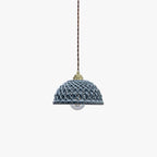 Clérachic pendant light in a room setting over a dining table.