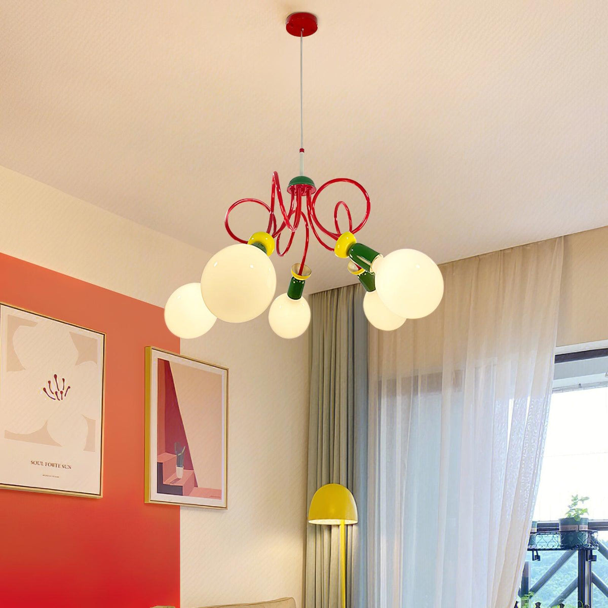 Clérachic cluster pendant with a red canopy, hung in a living room with a red-orange accent wall, sheer curtains and a yellow floor lamp.