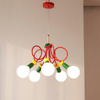 Five-bulb Clérachic pendant on a red ceiling plate, its green sockets and red loops set against a plain cream wall.