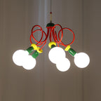Five bright globe bulbs light this Clérachic pendant against grey drapes, its red loops and green sockets clear above them.
