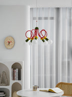 Clérachic pendant with its globes switched off, hung in front of white curtains above a table with an open book.