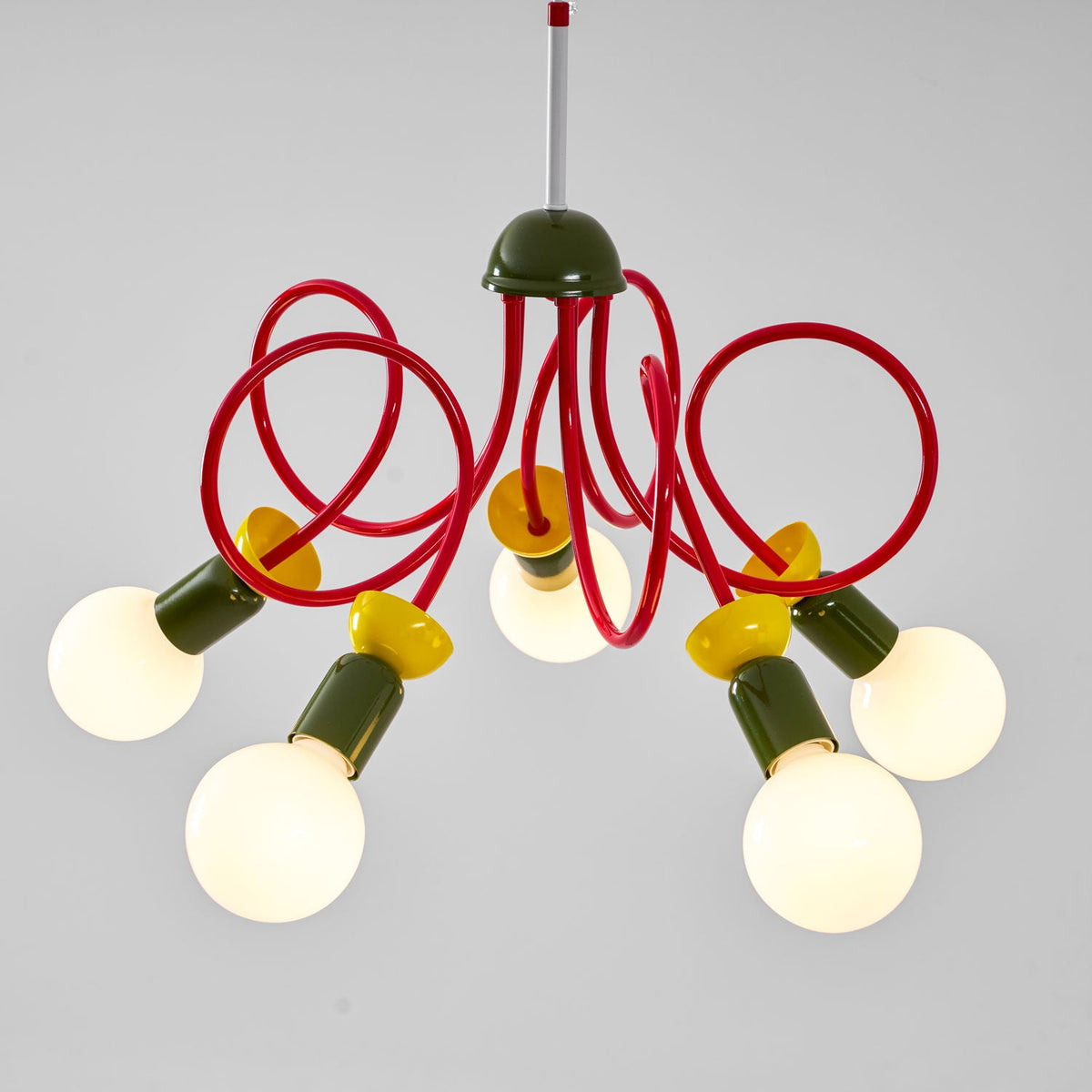 Close view of the green dome, red looping arms and five lit globes of this Clérachic pendant.