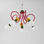 Looking up at this Clérachic pendant, five globe bulbs reach out on red looping tubes under a green cap.