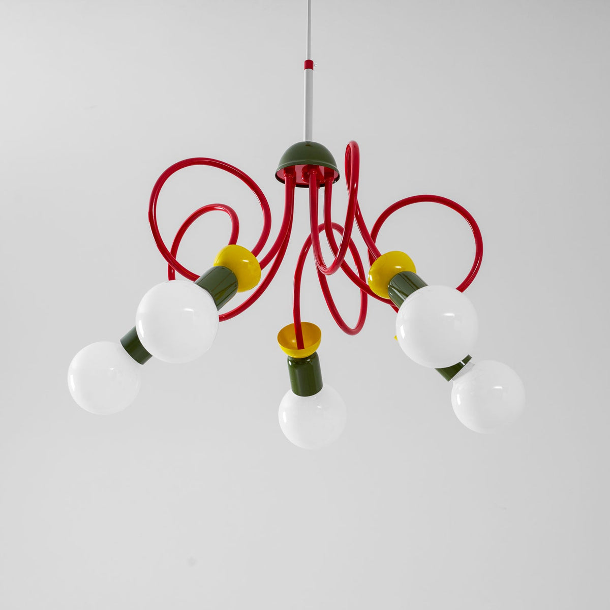 Looking up at this Clérachic pendant, five globe bulbs reach out on red looping tubes under a green cap.
