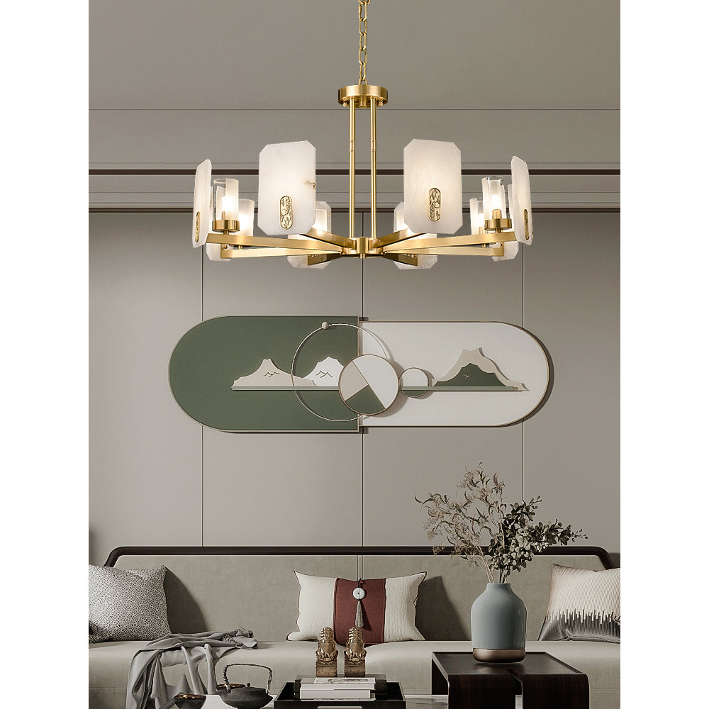Clérachic Meridian Alabaster Chandelier above a low sofa, its brass spokes echoing the oval green wall panel behind it.