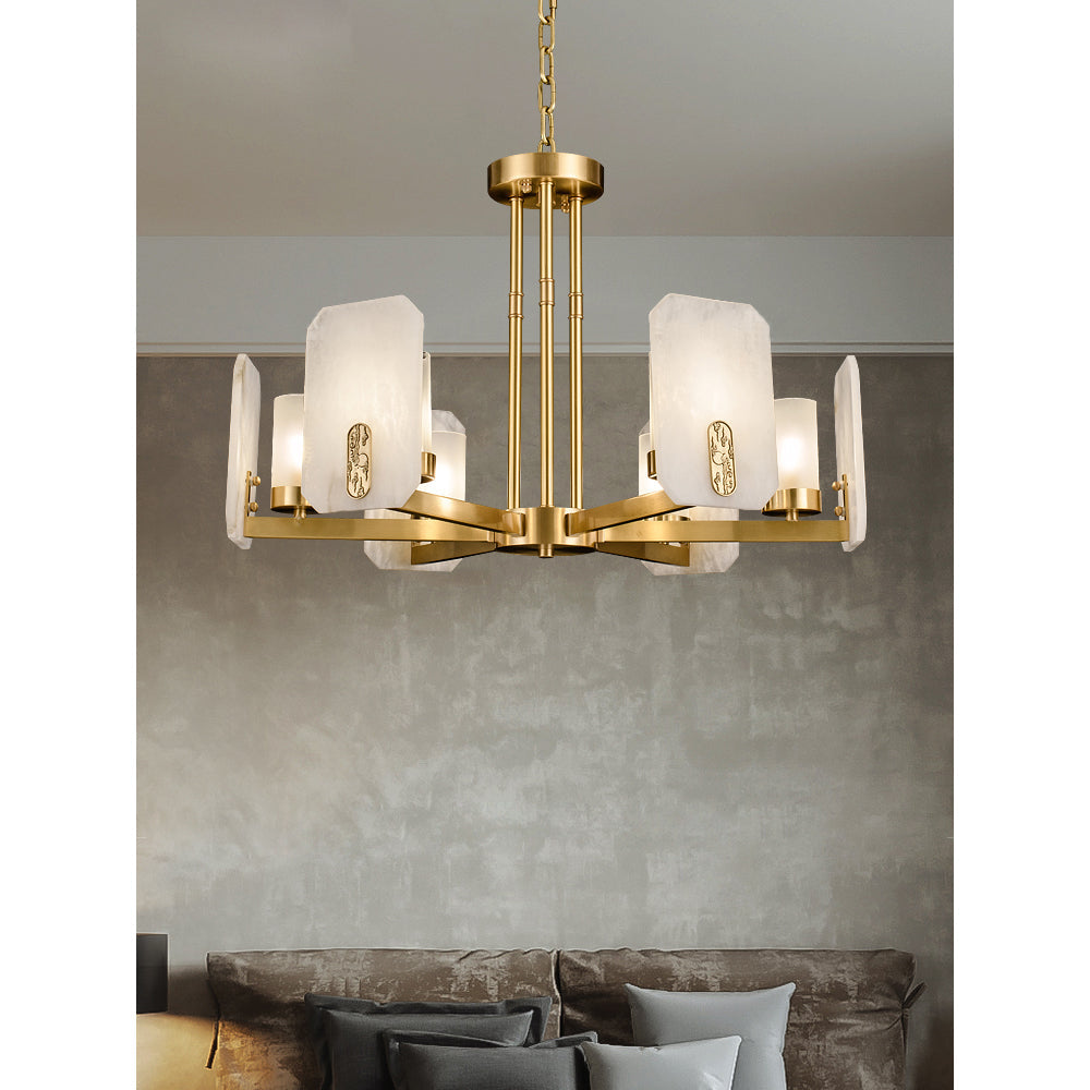 Clérachic Meridian Alabaster Chandelier seen close against a grey plaster wall, each lit panel edged by a cast brass medallion.