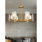 Clérachic Meridian Alabaster Chandelier seen close against a grey plaster wall, each lit panel edged by a cast brass medallion.