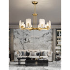 Clérachic Meridian Alabaster Chandelier over a cream sofa, hanging in front of a book-matched grey marble feature wall.
