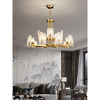 Fifteen-light Clérachic Meridian Alabaster Chandelier lit over a living room, both tiers glowing against a crane-and-mountain mural.