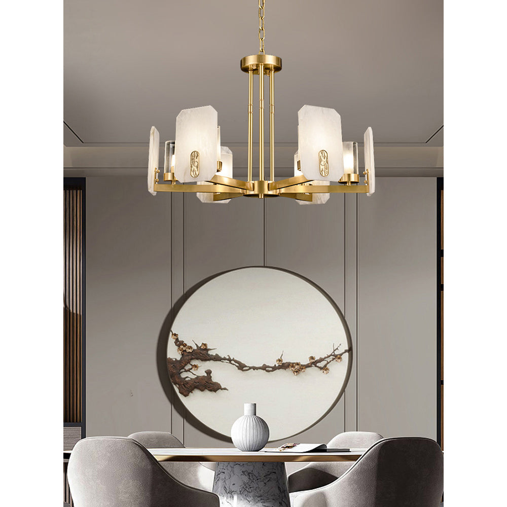 Clérachic Meridian Alabaster Chandelier above a dining table, its six warm heads framed by a round blossom-branch wall piece.