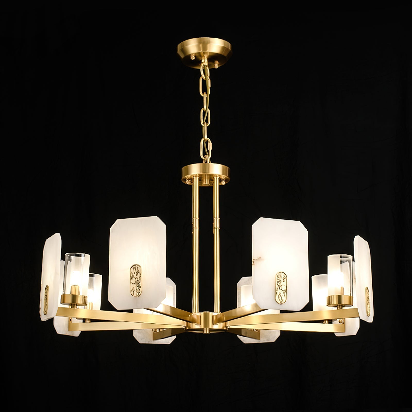 Clérachic Meridian Alabaster Chandelier lit on black with its full chain drop, eight panels ringing the central brass hub.