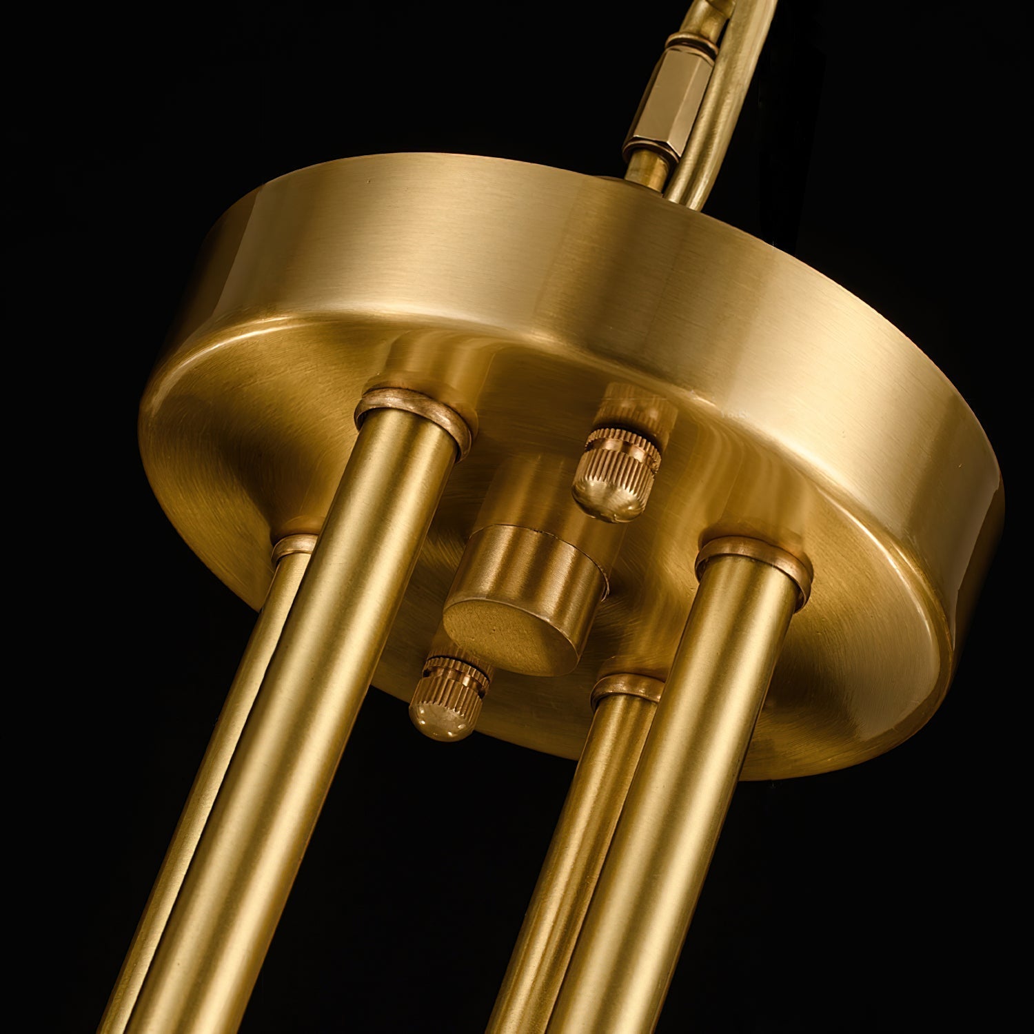 Clérachic Meridian Alabaster Chandelier detail, the brushed brass ceiling plate with knurled screws holding the three stems.