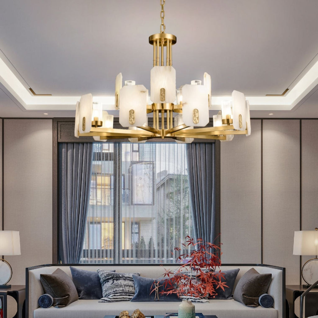 Clérachic Meridian Alabaster Chandelier, fifteen lights lit above a cream sofa in a panelled room with a tall curtained window.