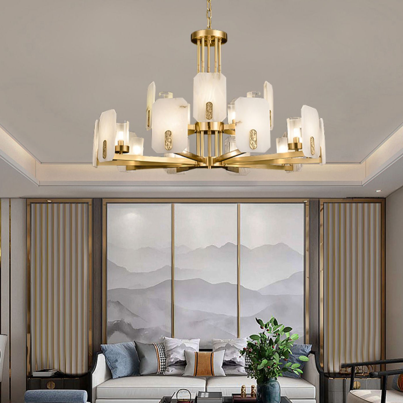 Clérachic Meridian Alabaster Chandelier in fifteen lights, glowing above a sofa and a triptych of grey mountain panels.