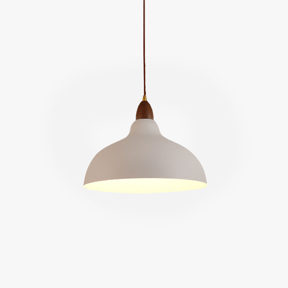 Clérachic black bowl pendant lit warm above a table
