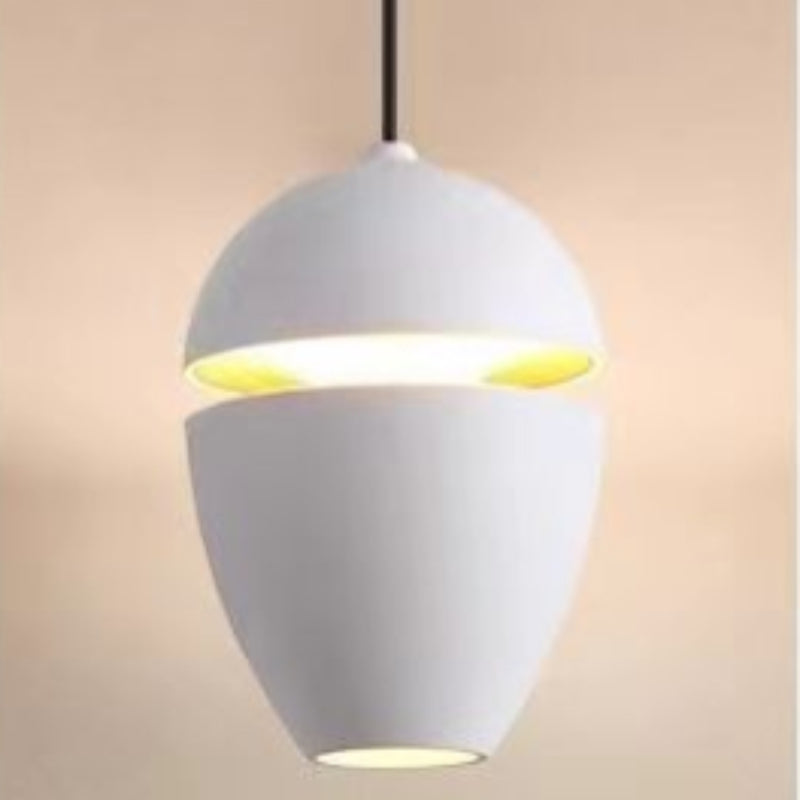 Clérachic matte white acorn pendant with a gold-toned interior glow through the horizontal gap.