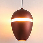 Clérachic bronze acorn pendant with a warm slit glow and a small downward opening at the base.