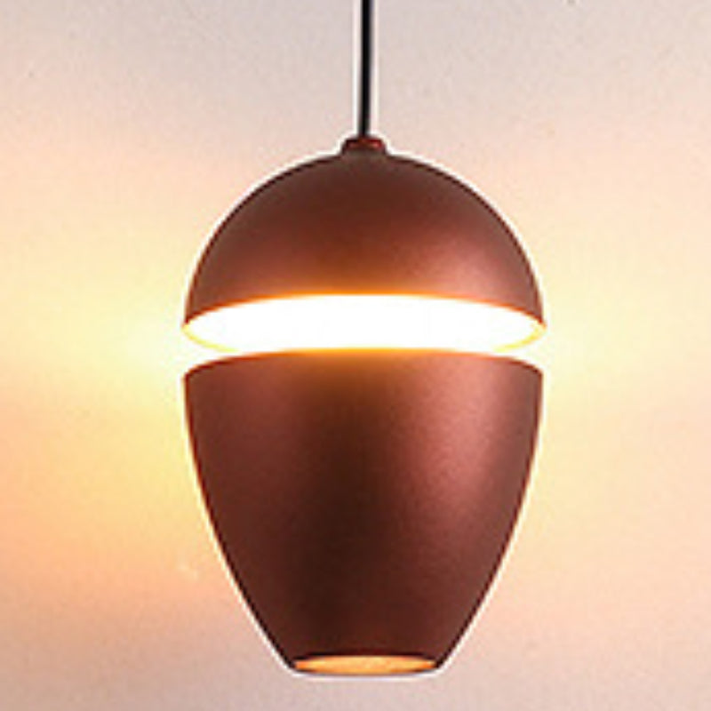 Clérachic bronze acorn pendant with a warm slit glow and a small downward opening at the base.