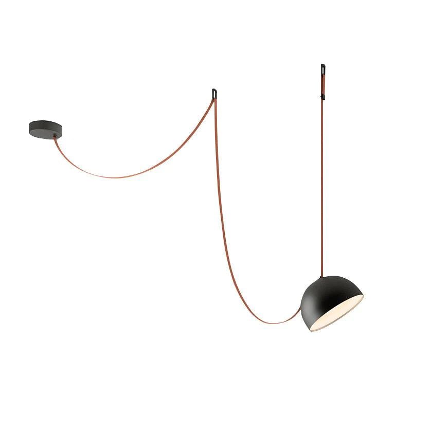 Black dome version of this Clérachic pendant light on white, with a red strap looping from the ceiling plate and a lit, pale interior.