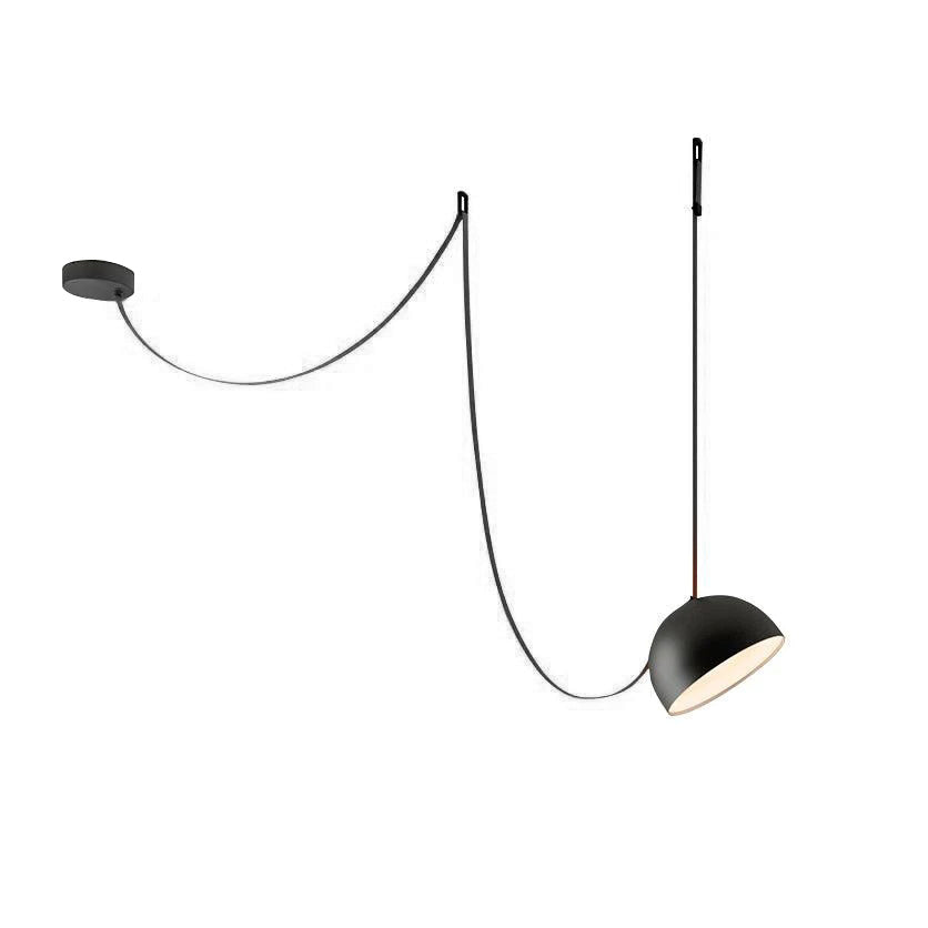 Black dome version of this Clérachic pendant light with a black strap, looped from a round ceiling plate and lit from within on white.