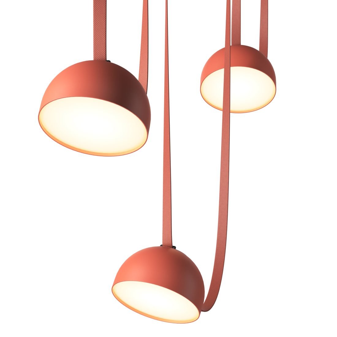 Looking up at three orange domes of this Clérachic pendant light, their warm white interiors glowing, with red straps hanging between.