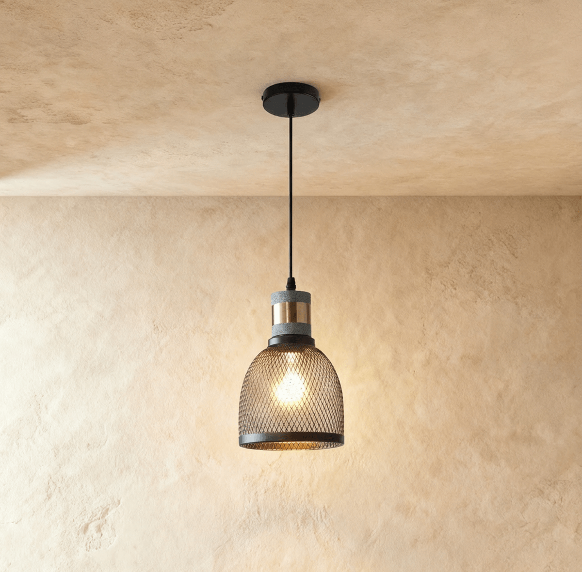 Clérachic domed black mesh pendant, 15 cm wide, with a grey stone-look collar and brass band, glowing with a bulb