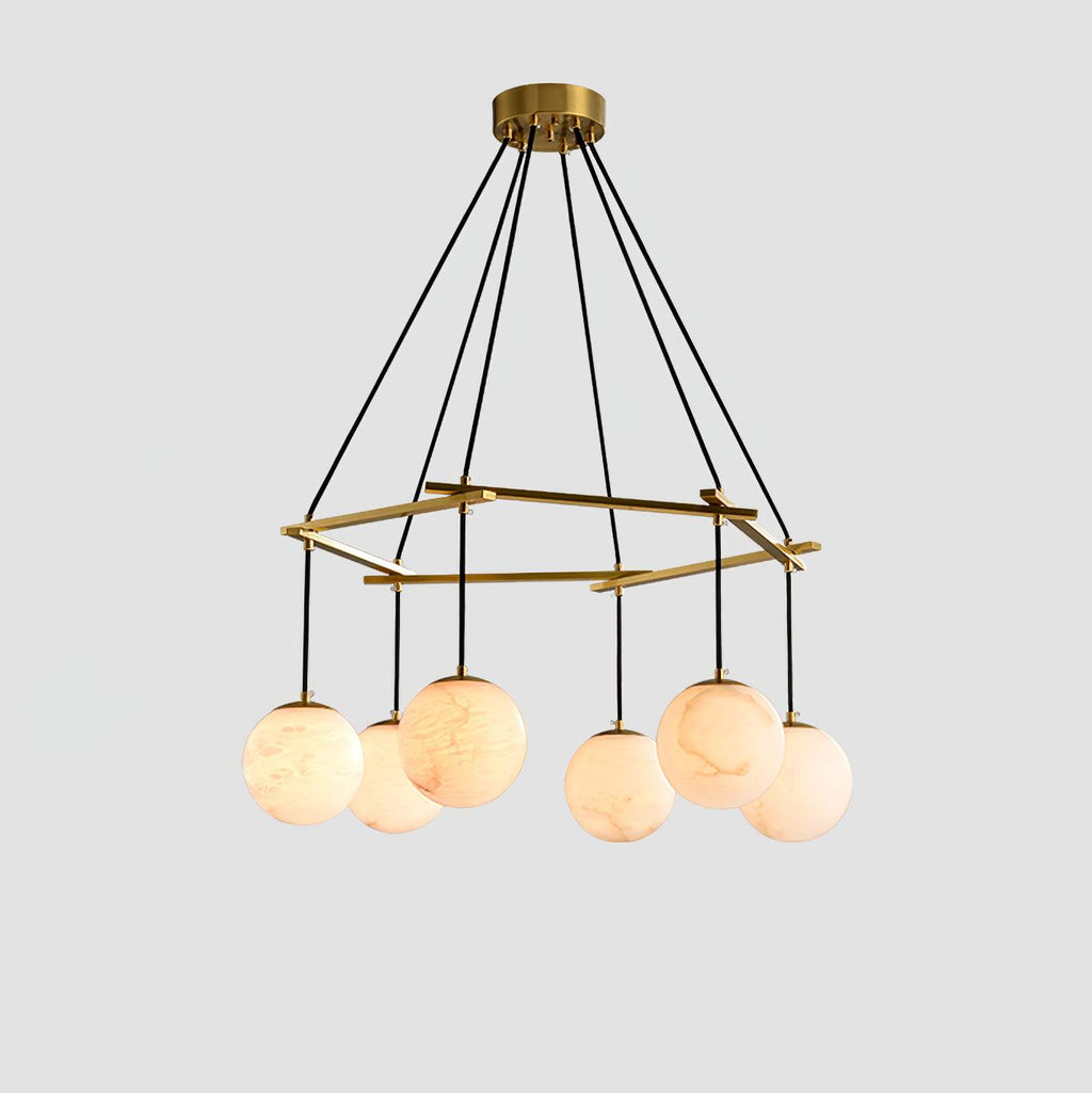 The six-orb Clérachic Miira chandelier, alabaster globes hung around a brass ring.