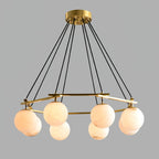 Clérachic Miira chandelier at its widest, alabaster orbs ringing the full brass frame.