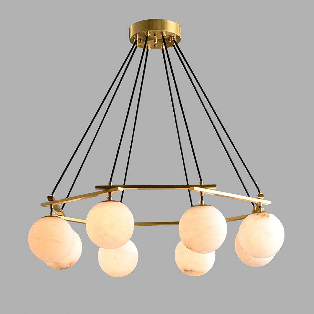 Clérachic Miira chandelier at its widest, alabaster orbs ringing the full brass frame.