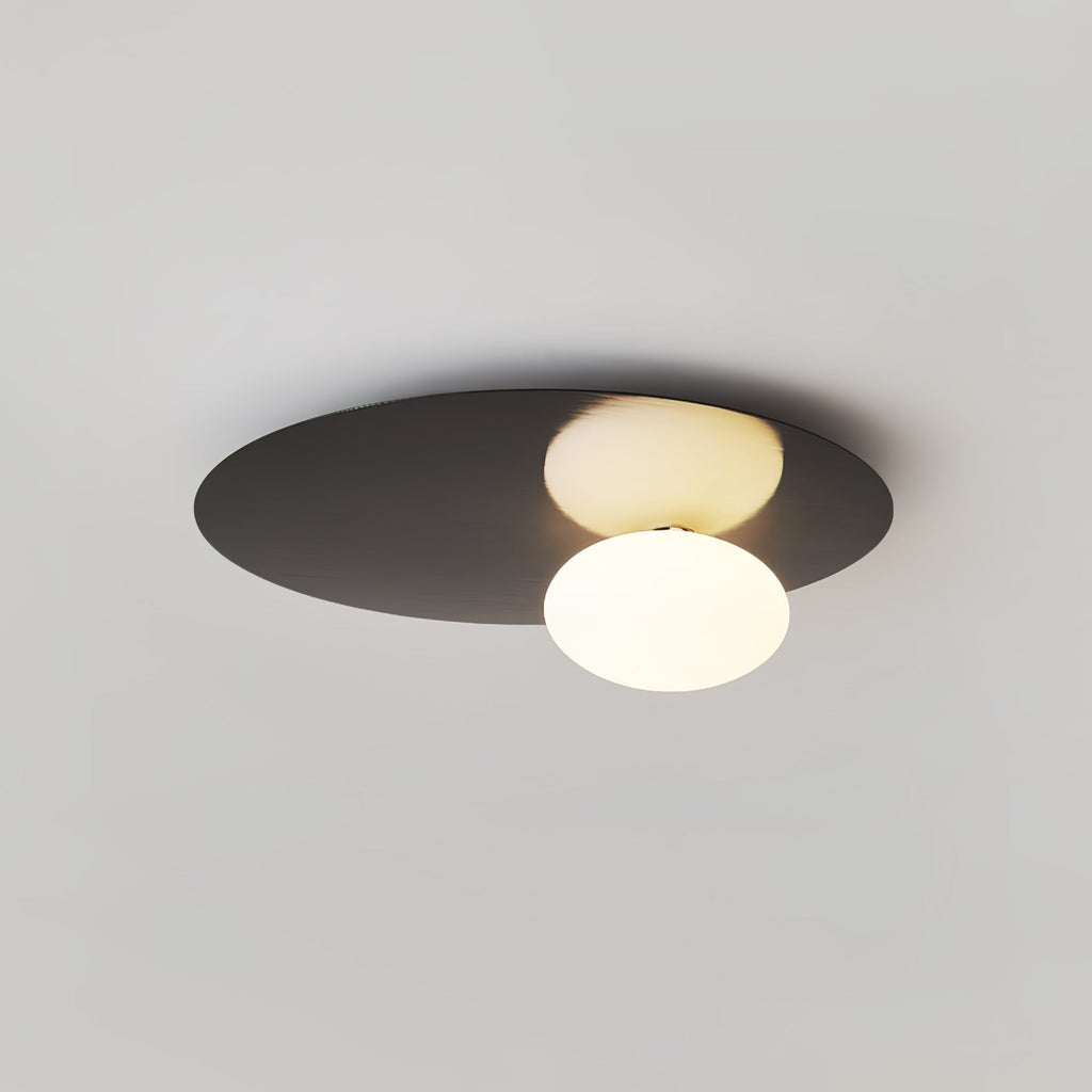Black Clérachic ceiling light with a glowing globe, shown at an angle against a pale grey ceiling.