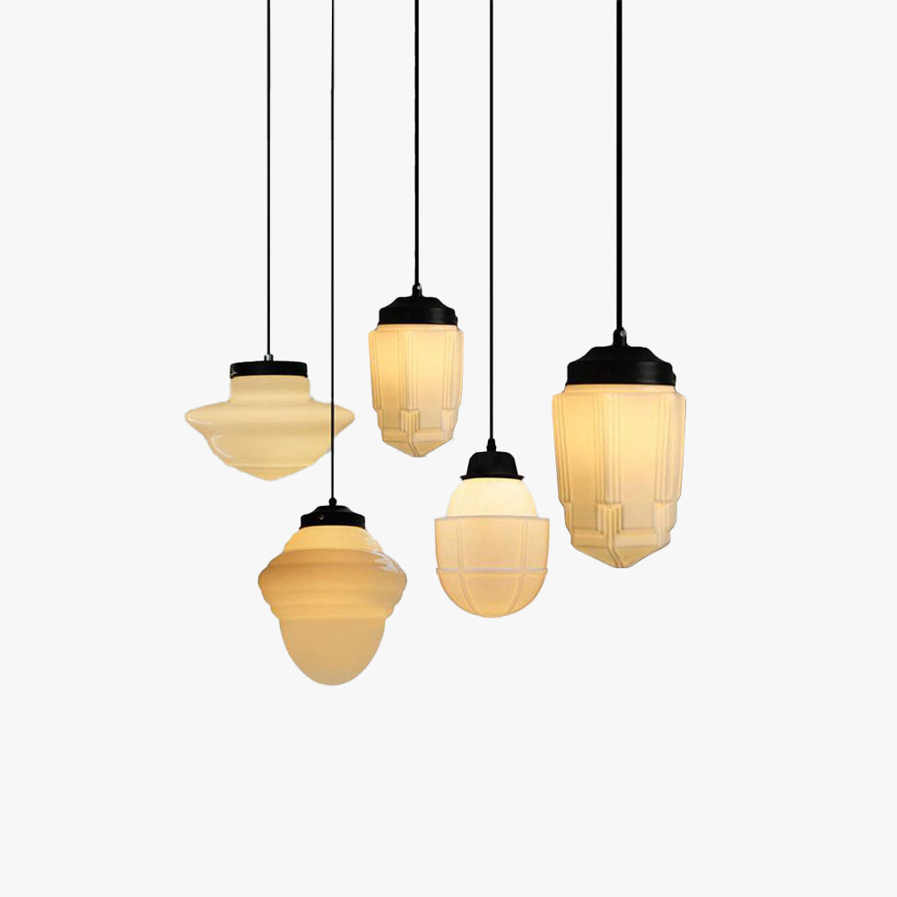 Clérachic milk glass pendant light shade profiles lined up on black cords at staggered drops on a plain white background.