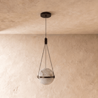 Clérachic alabaster globe pendant switched off, its pale veined stone held in a dark bronze band by three cords.