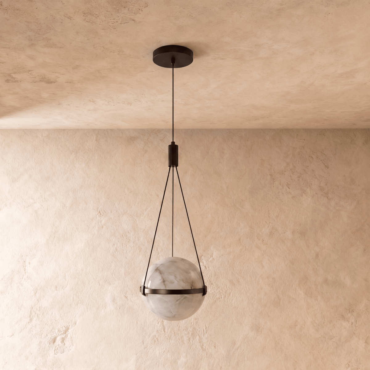 Clérachic alabaster globe pendant switched off, its pale veined stone held in a dark bronze band by three cords.