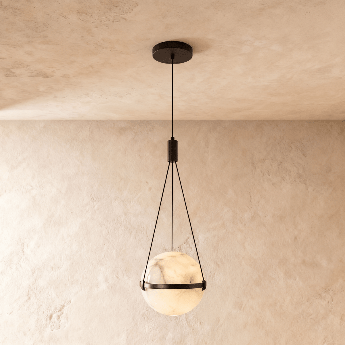 Clérachic marbled alabaster globe pendant with a slim dark metal band and three suspension cords, glowing softly on limewash.