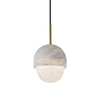 The Clérachic Mini Alabaster Globe Pendant seen straight on, brass stem and black fabric cord above the stone shade.