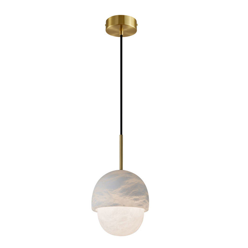 The Clérachic Mini Alabaster Globe Pendant at full drop, brass ceiling canopy above its long black fabric cord.