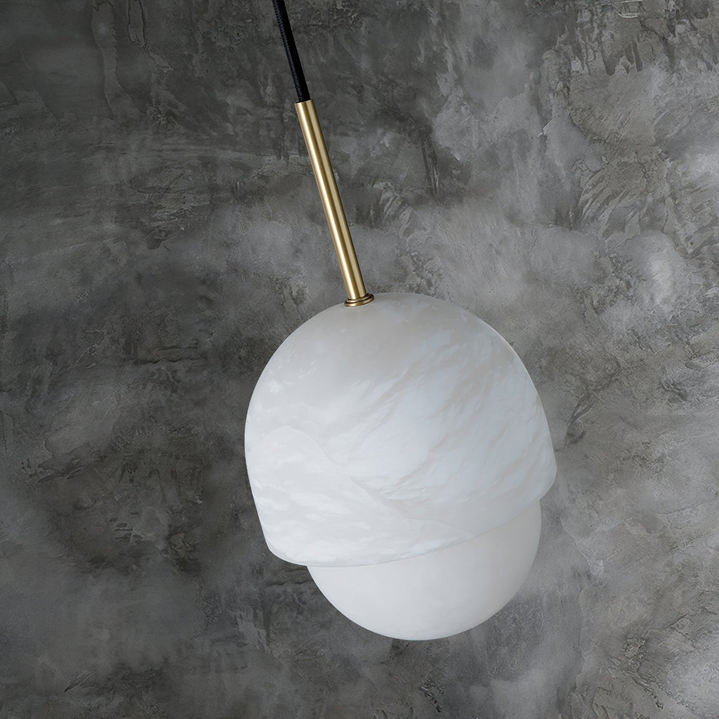 Clérachic Mini Alabaster Globe Pendant viewed from above, brass stem entering the alabaster cap at an angle.