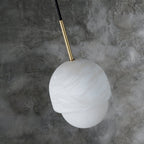 Clérachic Mini Alabaster Globe Pendant viewed from above, brass stem entering the alabaster cap at an angle.