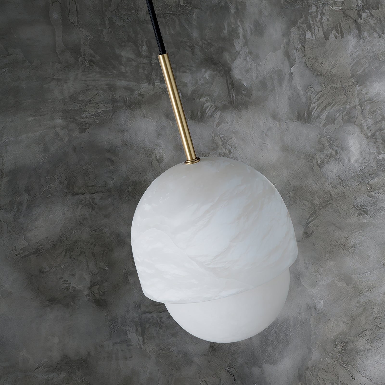 Clérachic Mini Alabaster Globe Pendant viewed from above, brass stem entering the alabaster cap at an angle.