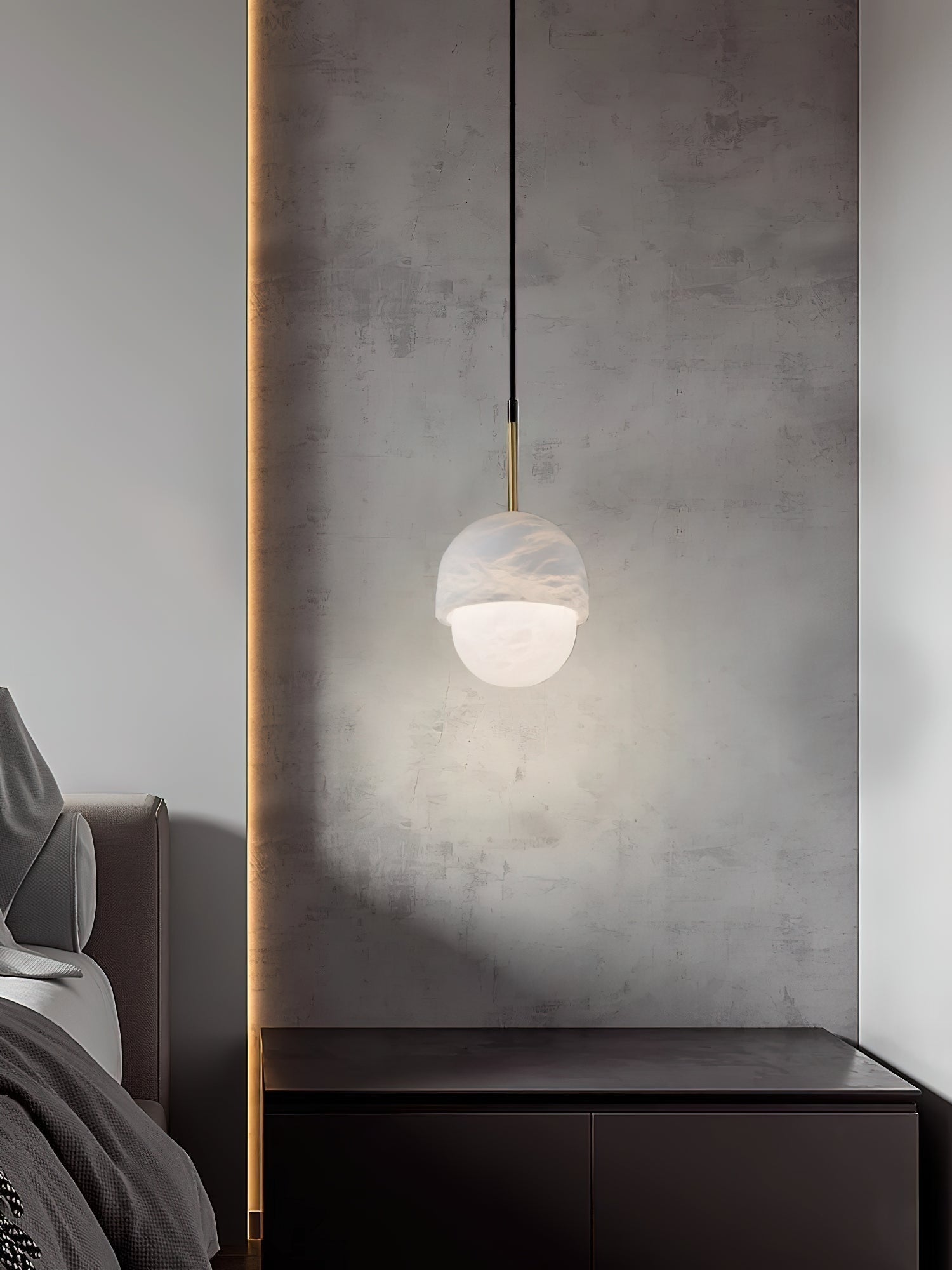 Clérachic Mini Alabaster Globe Pendant lighting a dark nightstand, its glow washing the concrete panel behind.